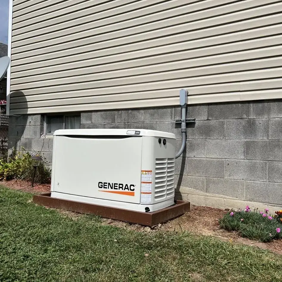 Generac generator installed with meter and transfer switch on a house wall