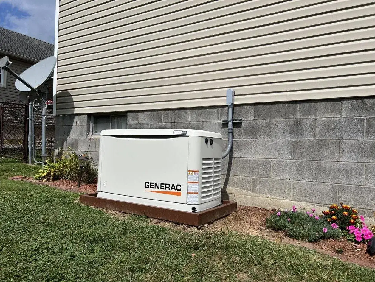 Generac standby generator on a pad beside a home in Belmont County, Ohio, installed by DC Electric