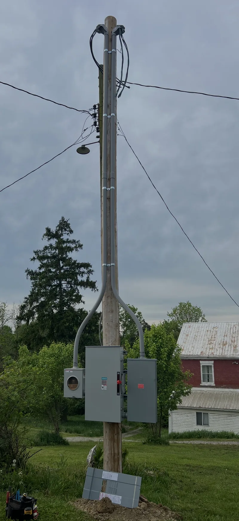 A farm service pole with the meter and disconnect mounted on it