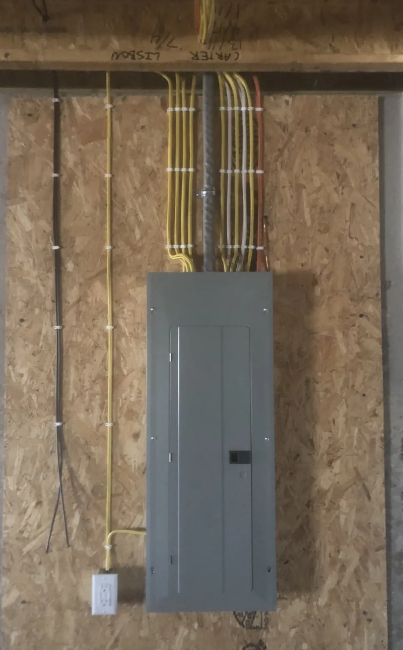 A new panel mounted on an OSB wall with the home runs coming in from above