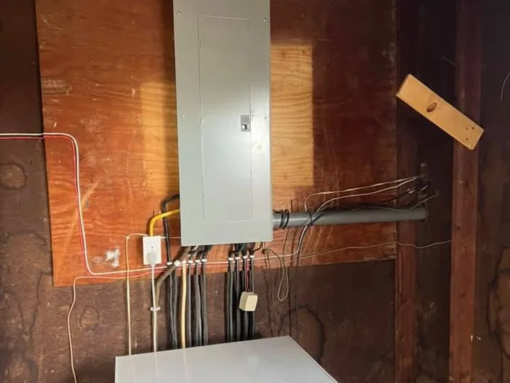 After: one new panel on the same plywood wall, every cable clipped and run straight