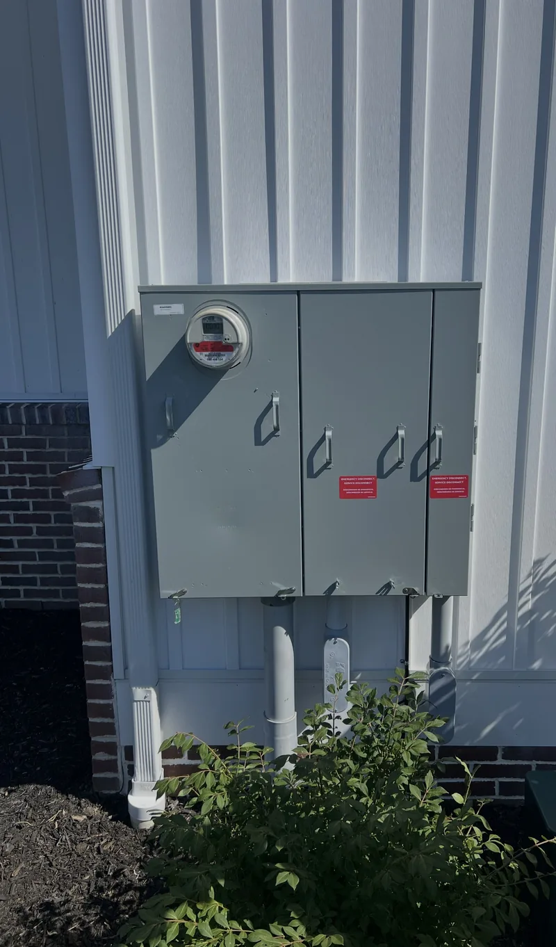 Meter and disconnects on the corner of a metal building